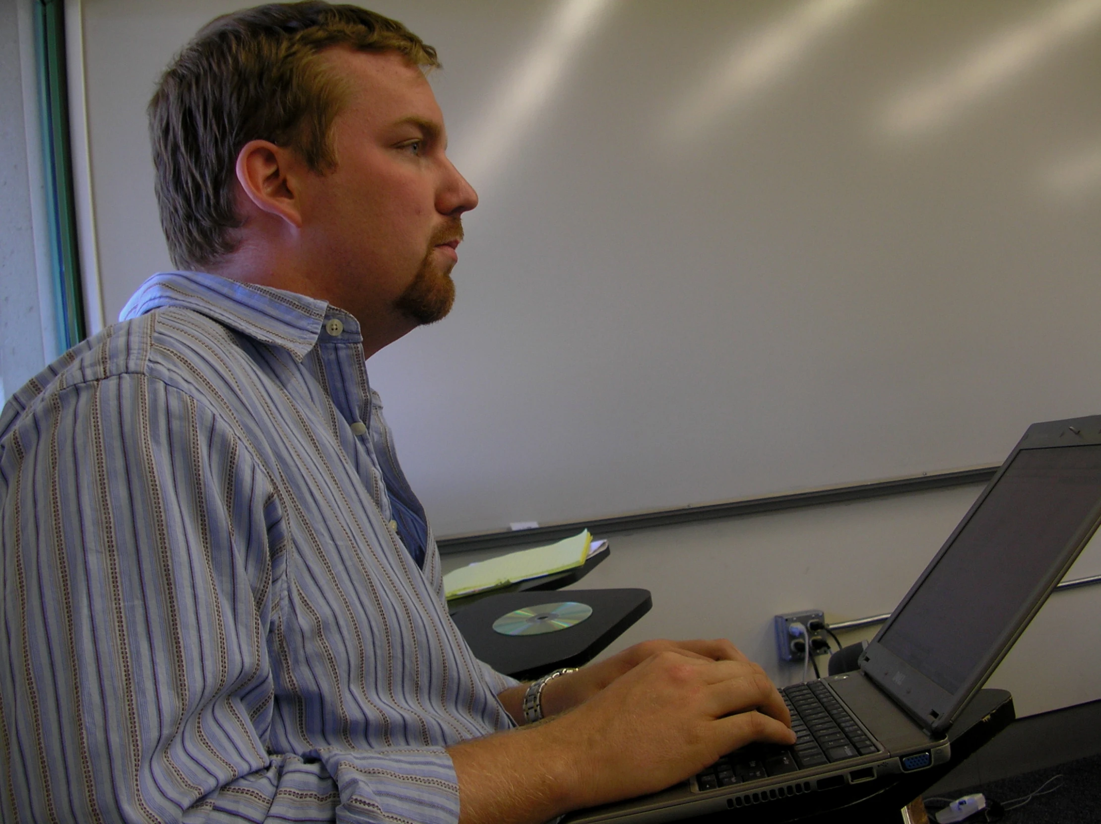 a man sitting in front of a laptop computer