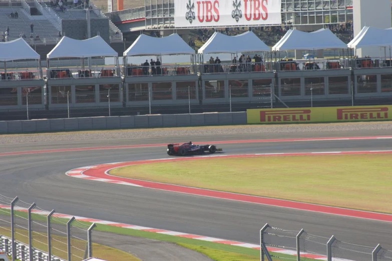 a man in a red race car on a track