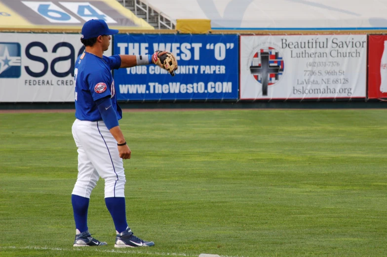 a baseball player holding a glove in his hand