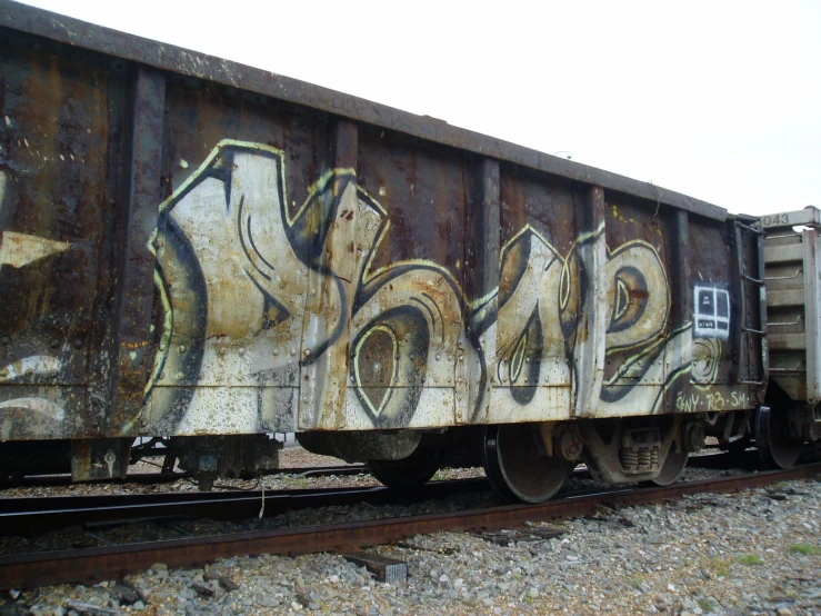graffiti is spray painted on the side of a train car