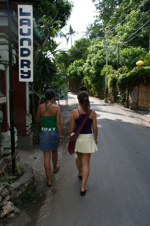 two girls walking down the street near the church