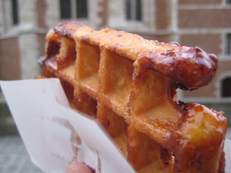 a person holding up an extra close up of a waffle