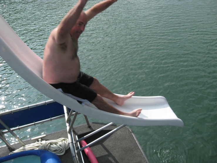 a man is sitting on a chair in the water