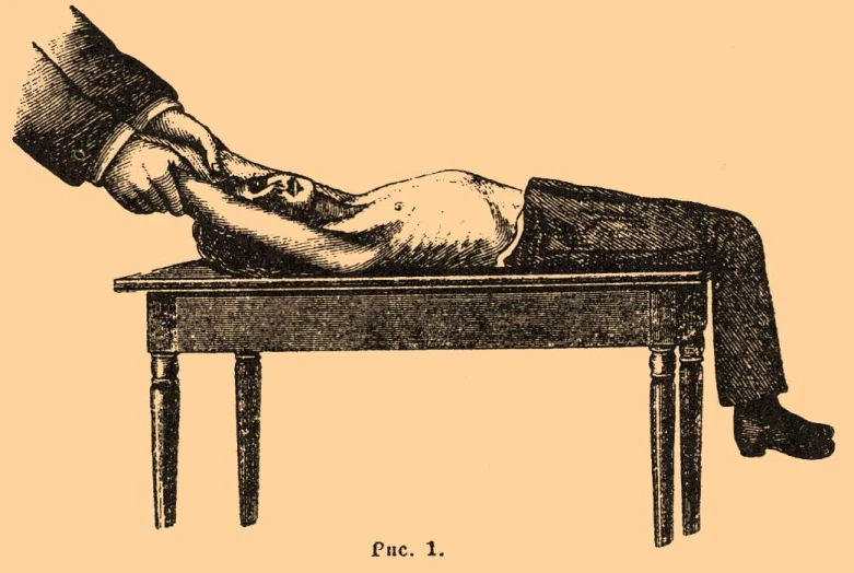 the back end of a man laying down on top of a table