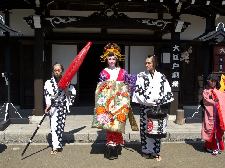 men dressed in geisha, playing instruments and dancing