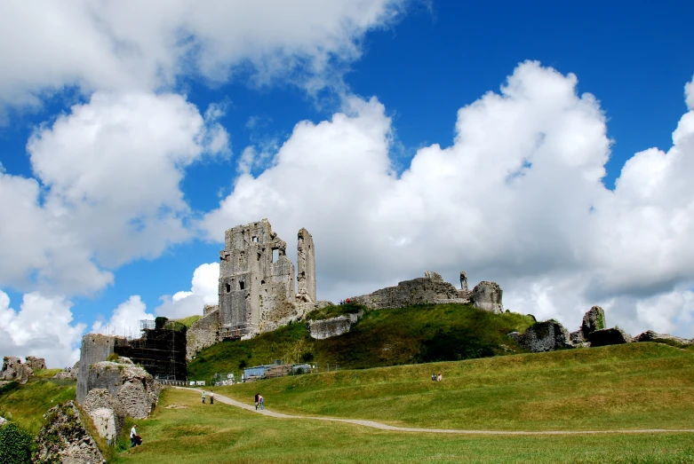 a stone castle on the top of a hill