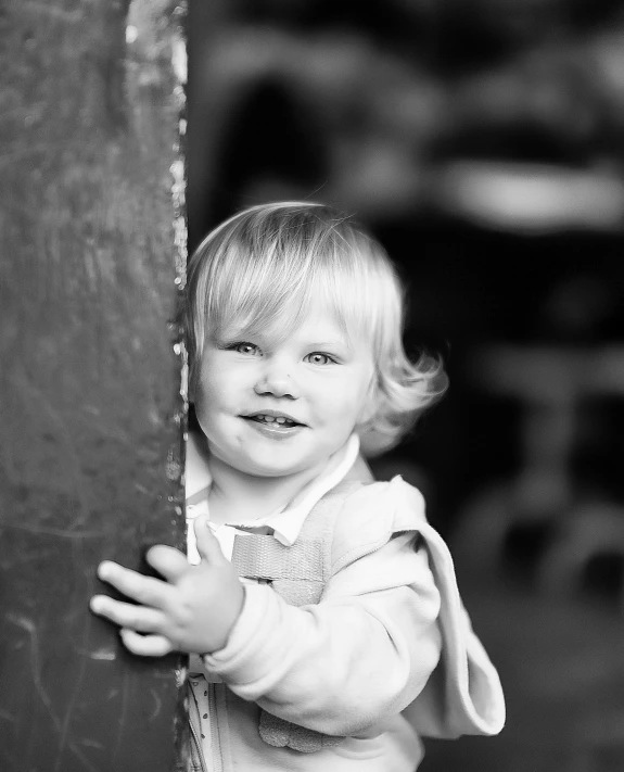 a black and white po of a toddler smiling