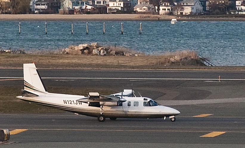 a single prop plane that is parked near a body of water