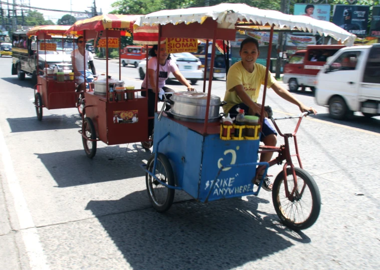 a man riding on a cart in the street