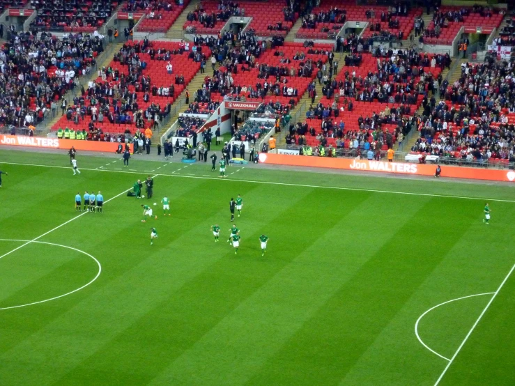 a soccer game in progress with the ball headed towards goal