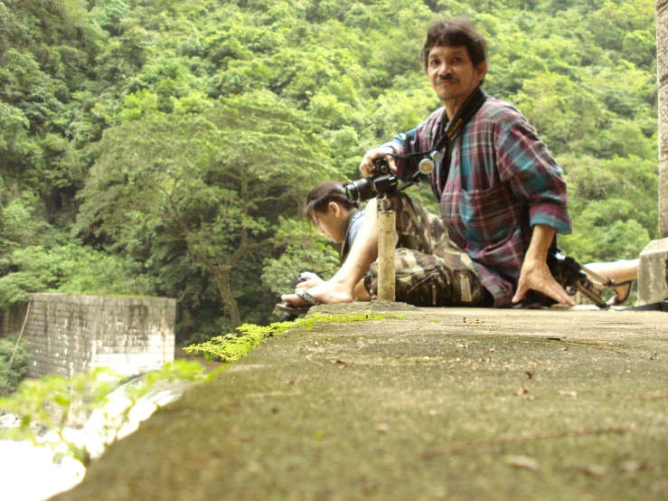 a man on a motorcycle that is leaning on the wall