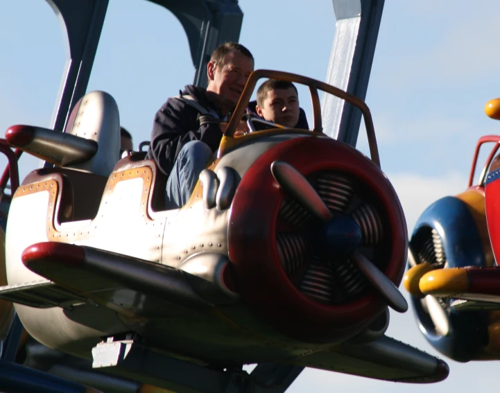 a man and woman sit in the cockpit of an airplane