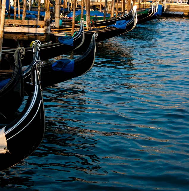 a number of small gondolas floating in a harbor