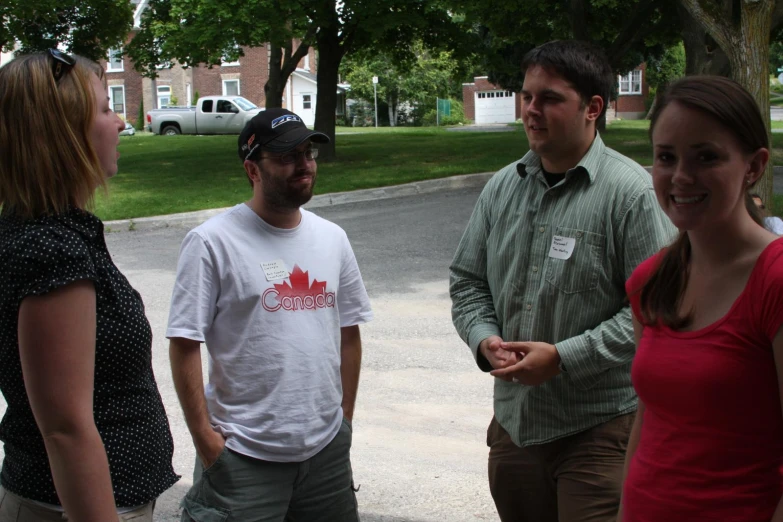 a group of people standing together outside of some buildings