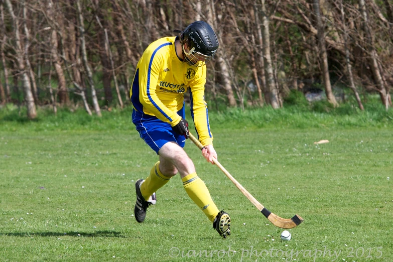 a lacrosse player is in action in a field
