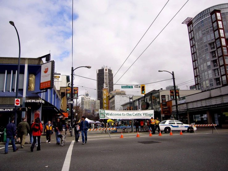 an intersection near a busy city intersection is shown with pedestrians, traffic and pedestrians