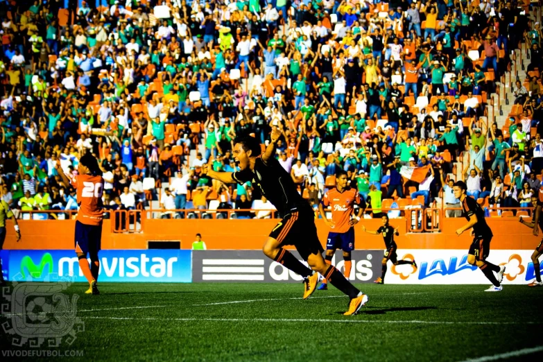 a couple of soccer players run towards a goal