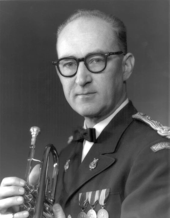 an old black and white po of a man in military uniform holding a trumpet