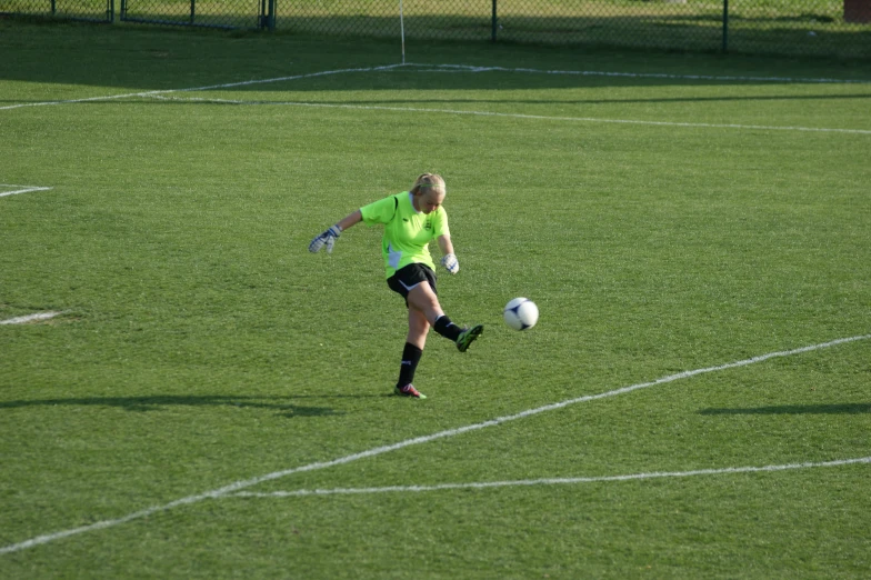 female soccer player about to kick the ball