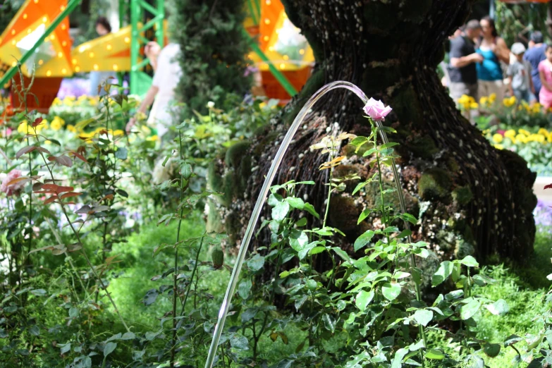 a water fall in the middle of some flowers