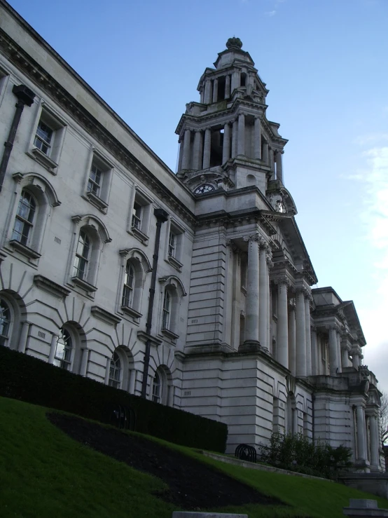 a large gray building with a tower and clock on top of it