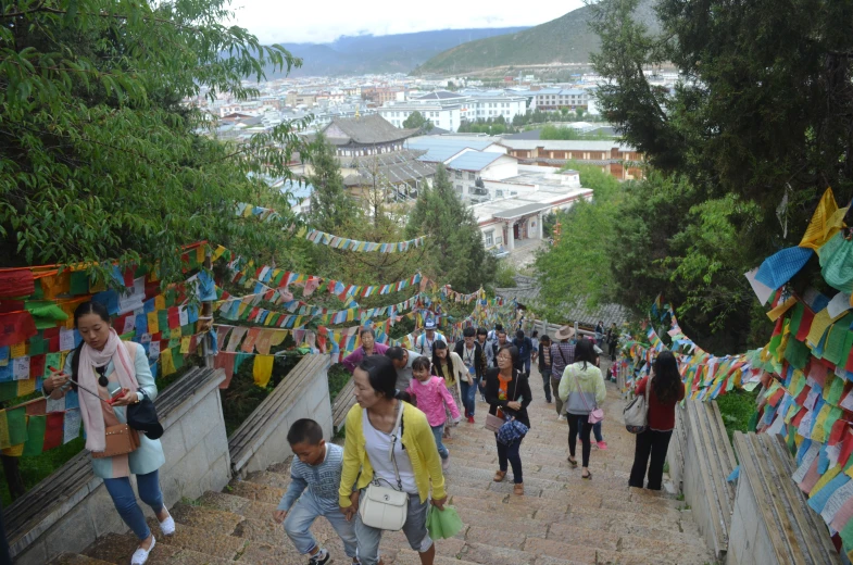 the people are going down the stairs at the base of the hill