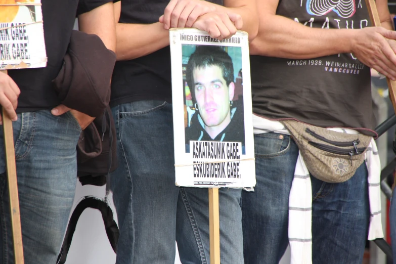 a protest poster with a man holding a sign with a newsprint on it