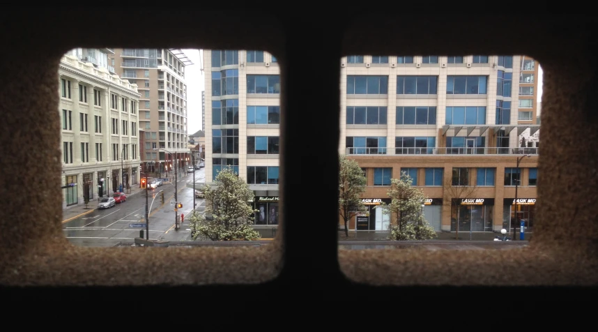 view of a city street taken through two windows