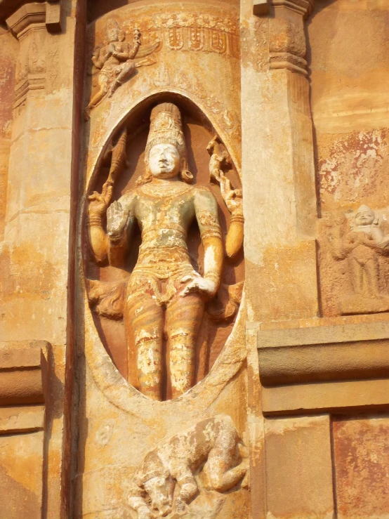 statue with large hands on wall in ornate setting