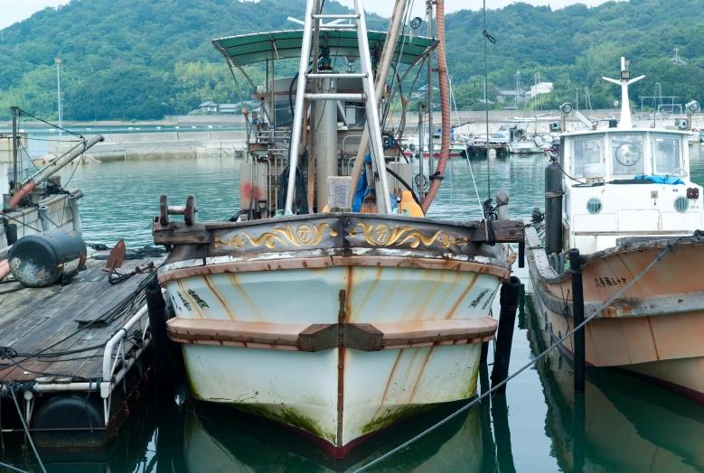 two boats tied up next to each other