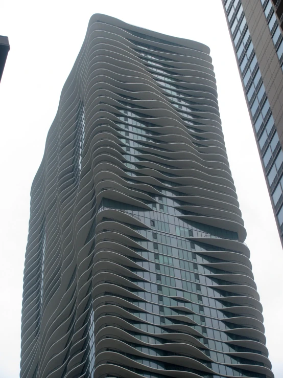 two very tall buildings with tall glass windows in the front of it