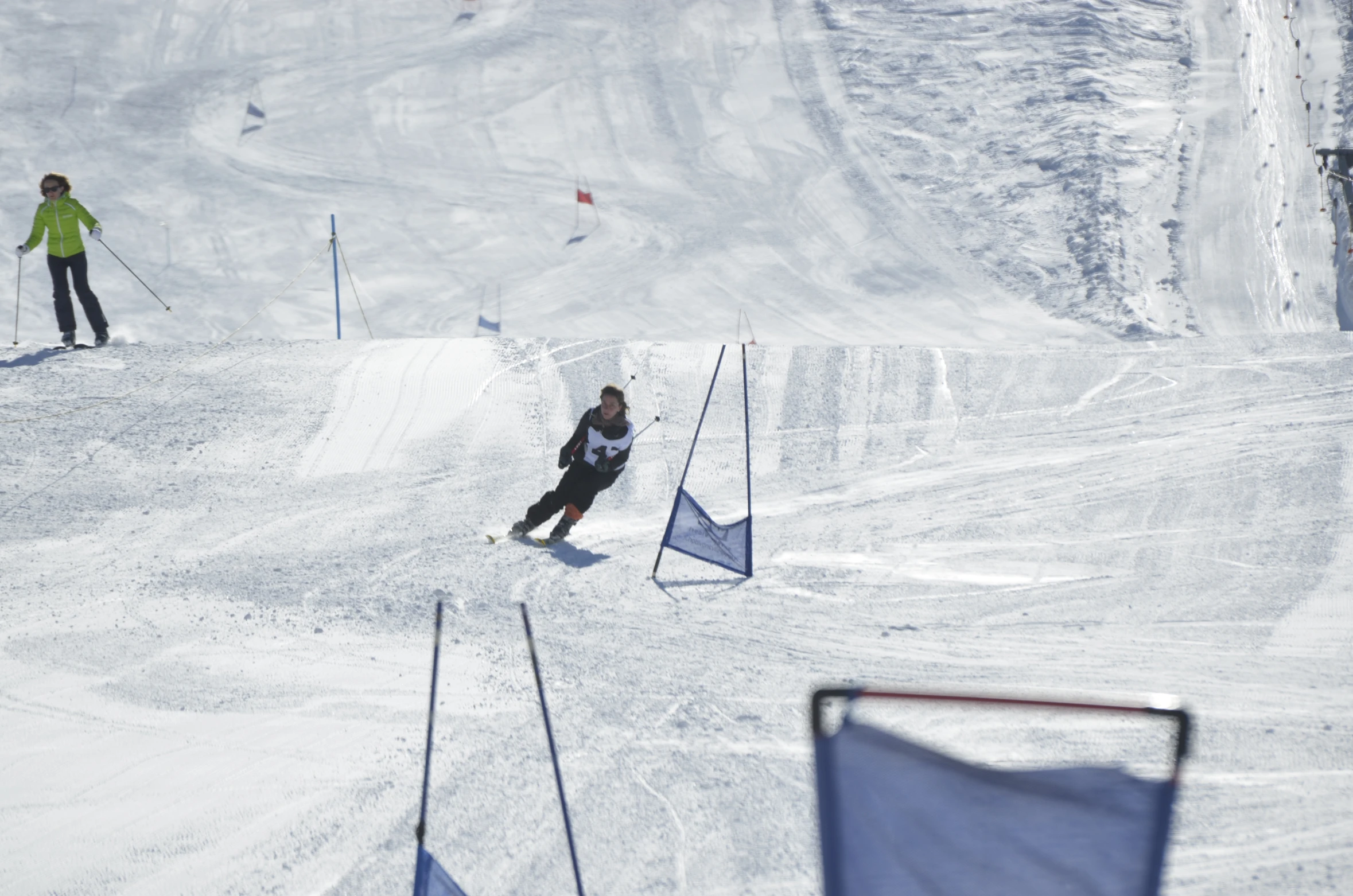 people in snow gear skiing down a hill