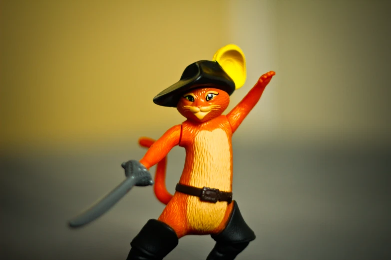 this toy figure is holding a sword with its claws