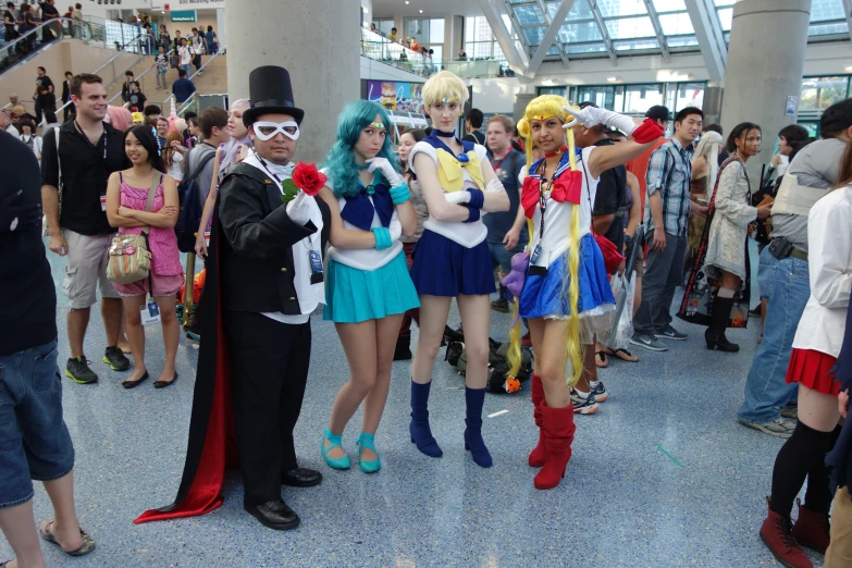 several characters stand together in costumes at a convention