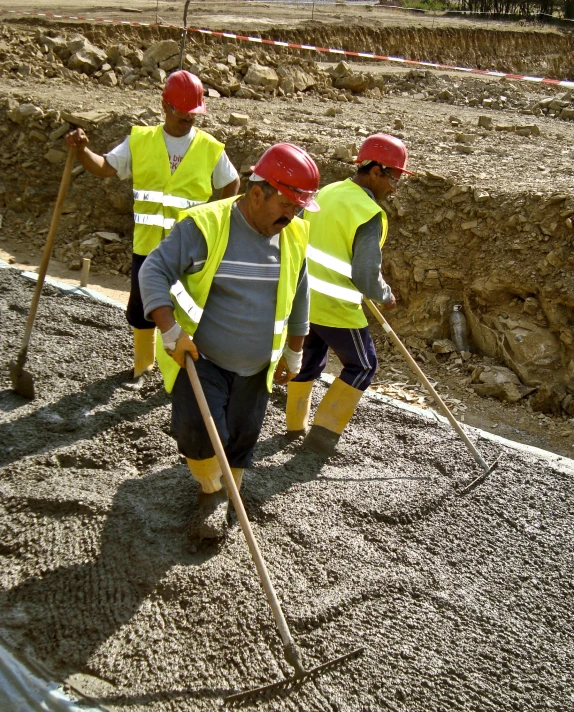 a group of men wearing safety gear working together