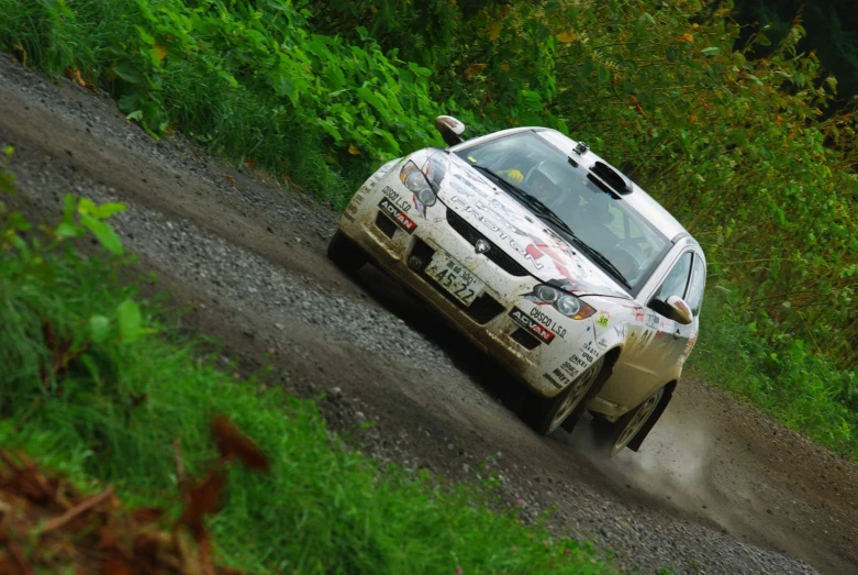 a rally car going down the dirt road