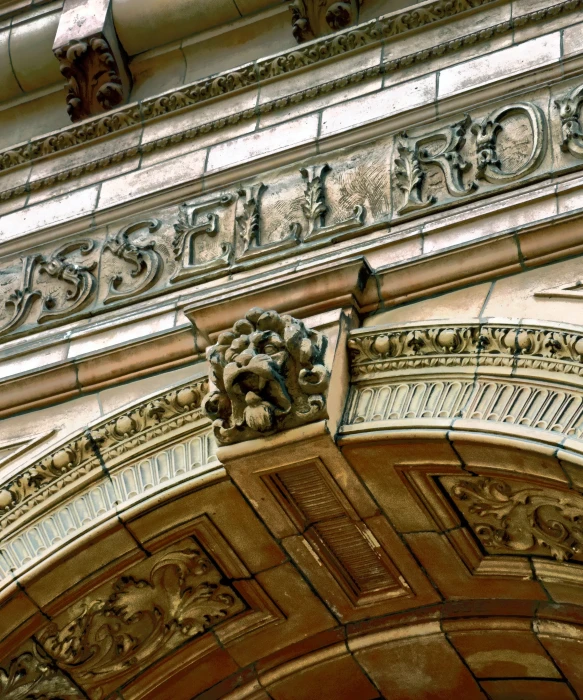 an arch above a door is carved with animals and other details