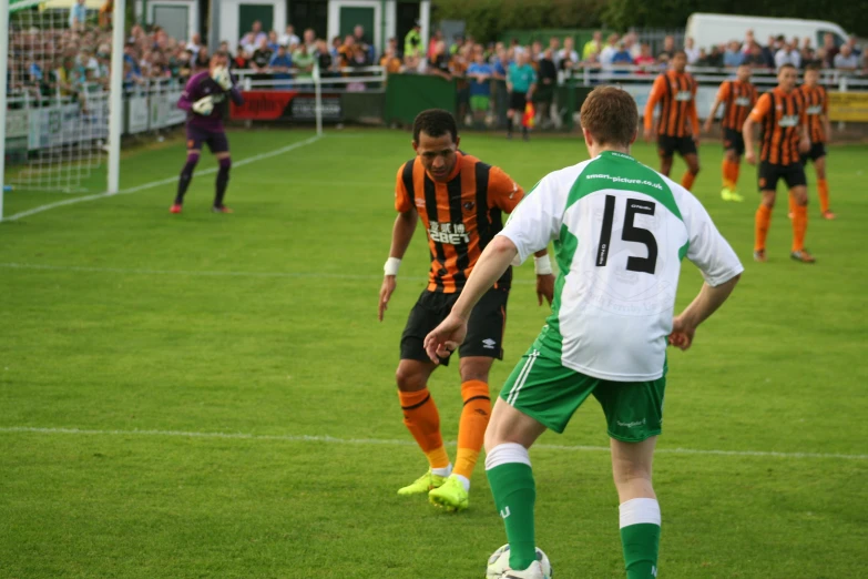 two soccer players are fighting over the ball