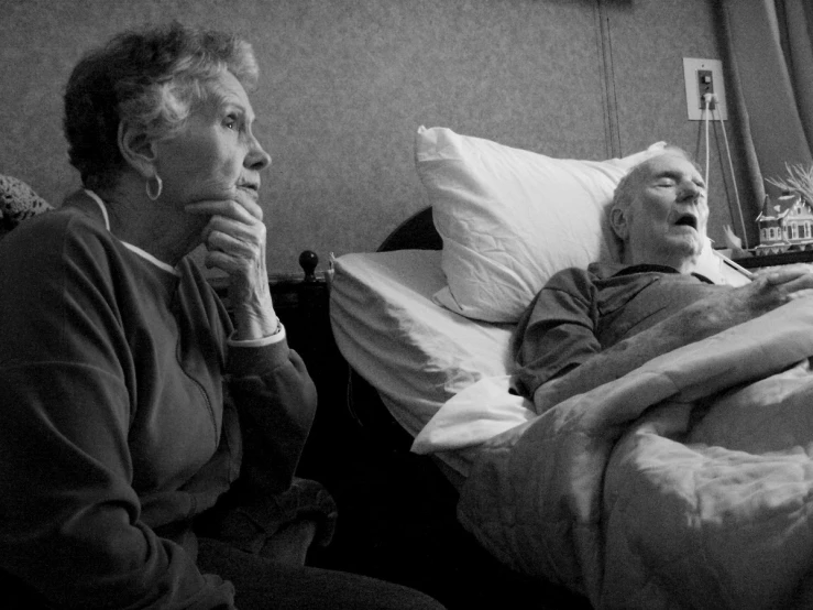 an elderly woman is sleeping with a patient