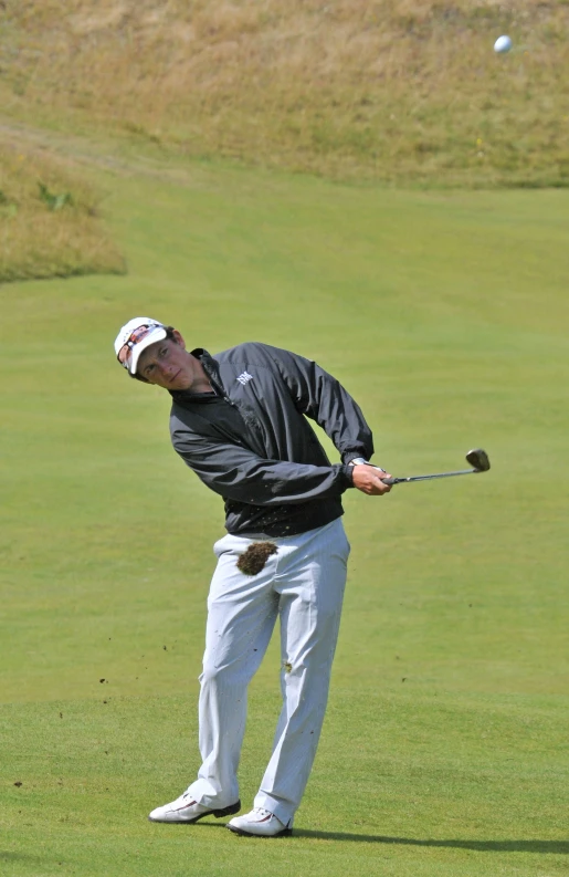 a man hitting a golf ball into the air