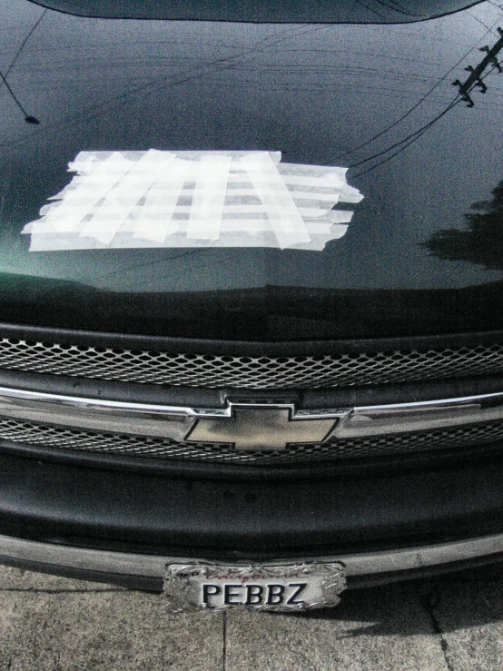 the front grill of an suv with a bumper sticker