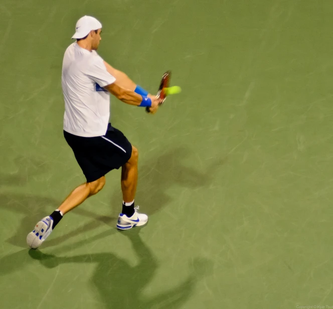 a man in a white shirt is playing tennis