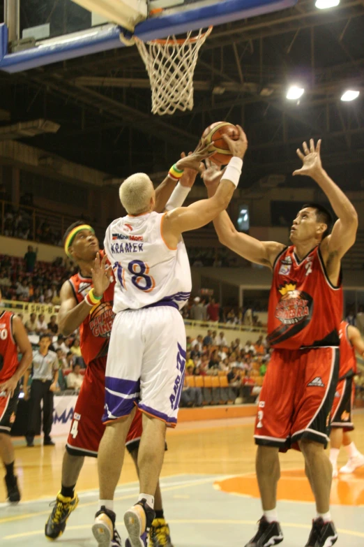 several basketball players are playing a game of basketball