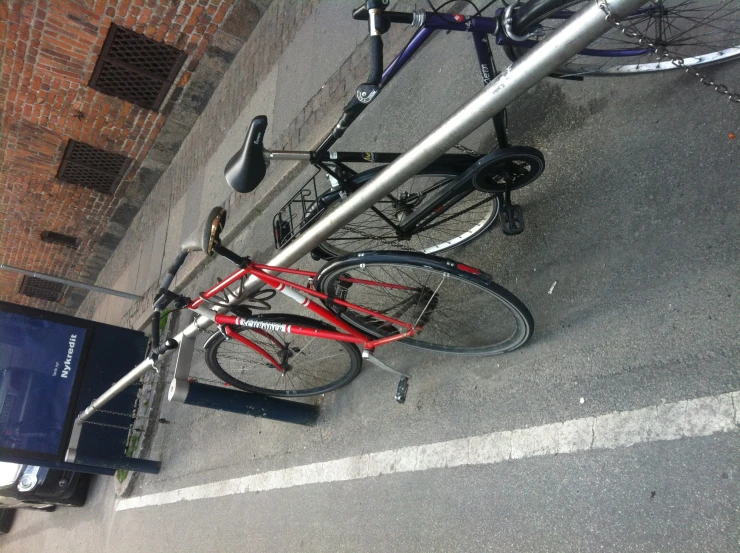 two bikes parked next to a metal fence near a bus