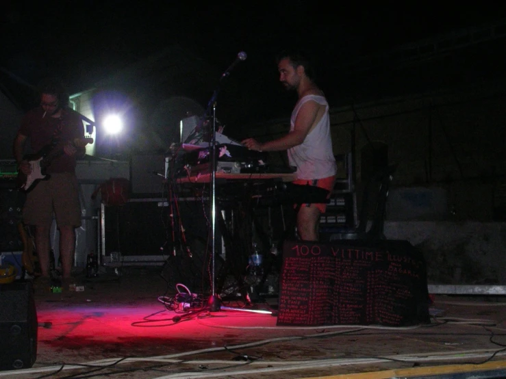 the band plays live music on stage with a man in shorts