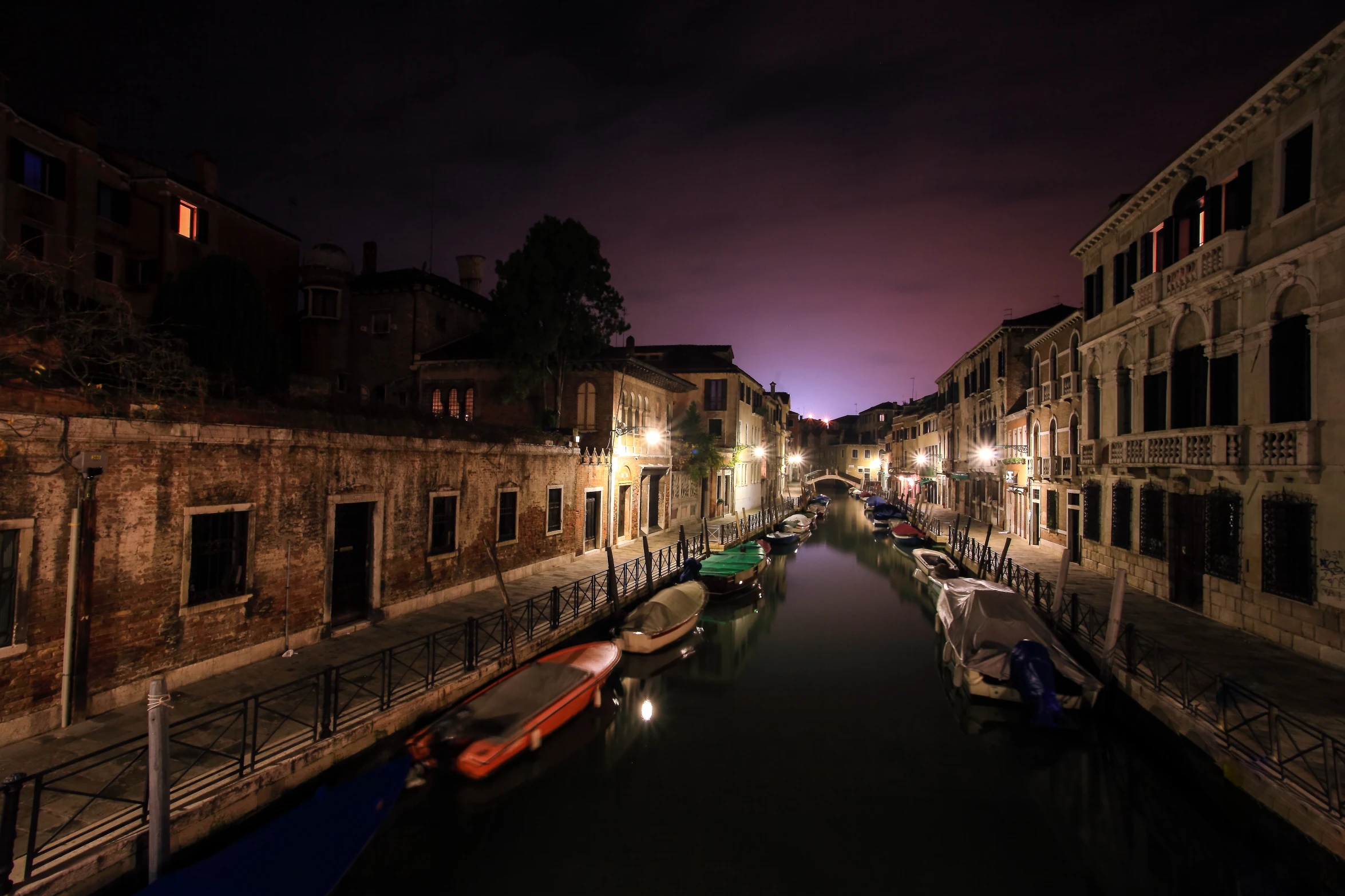 some boats are out on the water by some buildings