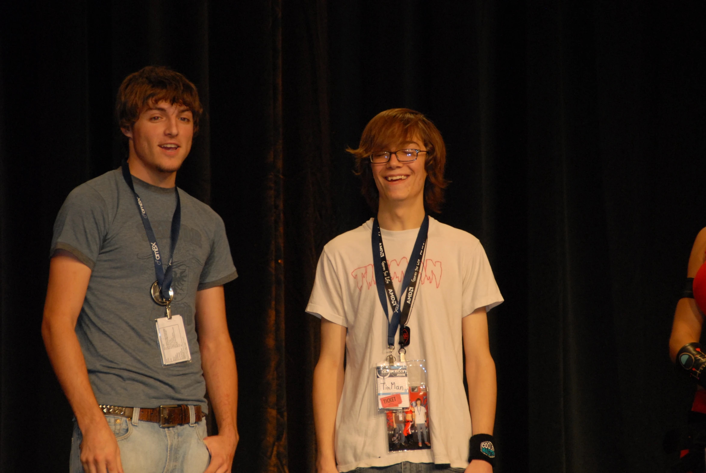 two men standing next to each other smiling