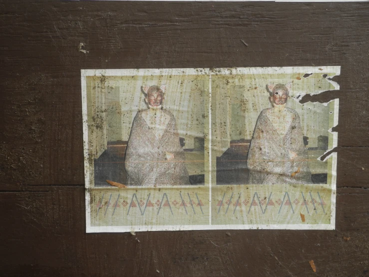 an old pograph of a woman in her native dress on some sort of wood