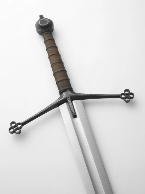 an old, fancy sword is propped on the wall