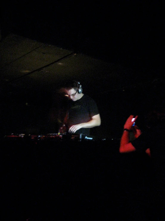 a dj in black shirt playing music on a set